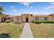 Inviting single-story home featuring lush green lawn and manicured landscaping at 18416 N Spanish Garden Dr, Sun City West, AZ 85375