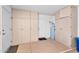 Well-organized garage features ample cabinet storage, water heater, and access door at 18416 N Spanish Garden Dr, Sun City West, AZ 85375