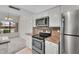 Kitchen features white cabinets, stainless steel appliances and stone countertops at 18416 N Spanish Garden Dr, Sun City West, AZ 85375
