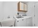 Functional laundry room equipped with a sink, washer, and dryer at 18416 N Spanish Garden Dr, Sun City West, AZ 85375