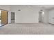 Open-concept living area with neutral carpeting and lots of natural light at 18416 N Spanish Garden Dr, Sun City West, AZ 85375