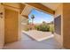 Covered patio offers an open view of the backyard brick patio and palm tree views at 18416 N Spanish Garden Dr, Sun City West, AZ 85375