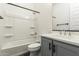 Clean bathroom featuring a tub, shower and a single sink vanity with black hardware at 18908 W Montebello Ave, Litchfield Park, AZ 85340