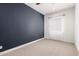 Bedroom featuring accent wall, carpet, and window at 18908 W Montebello Ave, Litchfield Park, AZ 85340
