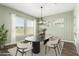 Dining room with a modern table, neutral colors, decorative plants, and many windows to let in natural light at 18908 W Montebello Ave, Litchfield Park, AZ 85340