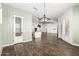 Stylish dining room with wood-look tile, open to the kitchen and living spaces, featuring a pantry at 18908 W Montebello Ave, Litchfield Park, AZ 85340