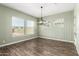 Charming dining room featuring wood-look tile, wainscoting, and ample natural light at 18908 W Montebello Ave, Litchfield Park, AZ 85340