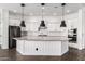 Spacious kitchen with a large island, sleek appliances, and stylish pendant lighting at 18908 W Montebello Ave, Litchfield Park, AZ 85340