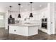 Bright kitchen with white cabinets, large island, and stainless steel appliances at 18908 W Montebello Ave, Litchfield Park, AZ 85340
