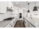 This kitchen is equipped with modern appliances, quartz countertops and hardwood floors at 18908 W Montebello Ave, Litchfield Park, AZ 85340