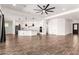 Expansive living area with wood-look tile, an open layout, and seamless flow to kitchen and dining spaces at 18908 W Montebello Ave, Litchfield Park, AZ 85340