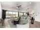 Bright living room with ceiling fan, large couch, recessed lighting and an open floor plan with views of the backyard at 18908 W Montebello Ave, Litchfield Park, AZ 85340