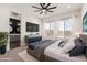 Main bedroom with a ceiling fan, neutral colors, and a large window with a view of the outside at 18908 W Montebello Ave, Litchfield Park, AZ 85340
