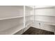 Organized walk-in pantry with ample shelving, maximizing storage space in the kitchen at 18908 W Montebello Ave, Litchfield Park, AZ 85340