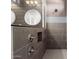 Spa-like walk-in shower with gray tiling, niche, and modern shower fixtures at 18908 W Montebello Ave, Litchfield Park, AZ 85340