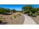 Scenic community walking path lined with desert landscaping and mature trees at 18908 W Montebello Ave, Litchfield Park, AZ 85340