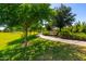 Picturesque community walking path with bench seating and shady trees at 18908 W Montebello Ave, Litchfield Park, AZ 85340