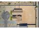 Overhead view of single-Gathering home's roof, landscaping, and a large empty lot at 2095 N 77Th Pl, Mesa, AZ 85207