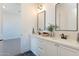 Bright bathroom with double vanity, modern fixtures, stone countertops, and decorative accents at 2095 N 77Th Pl, Mesa, AZ 85207