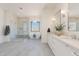 Luxurious bathroom featuring a soaking tub, glass shower, and double vanity with granite countertops at 2095 N 77Th Pl, Mesa, AZ 85207