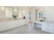 Elegant bathroom with dual vanities, stylish fixtures, and a well-lit makeup area at 2095 N 77Th Pl, Mesa, AZ 85207