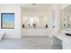 Modern bathroom with double vanities, sleek mirrors, and ample counter space at 2095 N 77Th Pl, Mesa, AZ 85207
