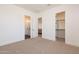 This bedroom leads to an ensuite bathroom and an open closet space that offers extra storage at 2095 N 77Th Pl, Mesa, AZ 85207