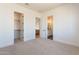 An open bedroom with a walk-in closet, plush carpeting, neutral walls and an ensuite bathroom at 2095 N 77Th Pl, Mesa, AZ 85207