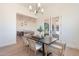 Dining room with a table, seating for six, and views into the kitchen and living areas at 2095 N 77Th Pl, Mesa, AZ 85207