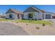 Charming single Gathering home featuring lush green lawns, gravel accents, and architectural design at 2095 N 77Th Pl, Mesa, AZ 85207