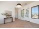 Elegant foyer featuring herringbone floors, natural light, and a console table at 2095 N 77Th Pl, Mesa, AZ 85207