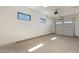 A well-lit, spacious garage with high ceilings and ample space for parking and storage at 2095 N 77Th Pl, Mesa, AZ 85207