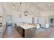 Spacious kitchen flowing into the living room, featuring an island with bar stools and stainless steel appliances at 2095 N 77Th Pl, Mesa, AZ 85207