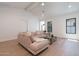 Open-concept living room with hardwood floors, neutral walls, vaulted ceiling and comfortable sectional sofa at 2095 N 77Th Pl, Mesa, AZ 85207