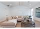 Open-concept living room boasts high ceilings, natural light, and a comfortable sectional sofa at 2095 N 77Th Pl, Mesa, AZ 85207
