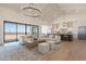 Open-concept living room and kitchen with hardwood floors and modern finishes at 2095 N 77Th Pl, Mesa, AZ 85207