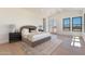 Spacious main bedroom with hardwood floors, a luxurious bed, and a view of the outdoors at 2095 N 77Th Pl, Mesa, AZ 85207