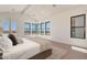 Bright main bedroom with floor-to-ceiling windows and neutral decor create a serene retreat at 2095 N 77Th Pl, Mesa, AZ 85207