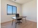 An inviting office space with a natural wood desk, black chair, and a well-lit, comfortable workspace at 2095 N 77Th Pl, Mesa, AZ 85207