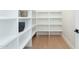 Bright pantry featuring custom white shelving and light wood flooring, perfect for organization at 2095 N 77Th Pl, Mesa, AZ 85207