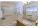 Traditional bathroom featuring a shower with glass doors, granite countertops, and a vanity at 21061 N 33Rd Dr, Phoenix, AZ 85027