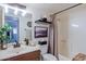 Renovated bathroom with a bathtub, shower with curtain, floating shelves, and modern fixtures at 21061 N 33Rd Dr, Phoenix, AZ 85027