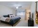 Comfortable bedroom with a ceiling fan, carpet, and a large window allowing natural light at 21061 N 33Rd Dr, Phoenix, AZ 85027