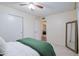 This bedroom features neutral walls, carpet flooring, a ceiling fan, and a large closet at 21061 N 33Rd Dr, Phoenix, AZ 85027