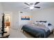 Comfortable bedroom featuring a ceiling fan, carpet, and a view to an ensuite bathroom at 21061 N 33Rd Dr, Phoenix, AZ 85027