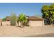 Single-story home with a two-car garage, desert landscaping, and a clear blue sky at 21061 N 33Rd Dr, Phoenix, AZ 85027
