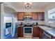Updated kitchen with stainless steel appliances, granite countertops, and wood cabinets at 21061 N 33Rd Dr, Phoenix, AZ 85027