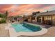 Backyard oasis featuring a sparkling pool, fire pit, covered patio, and outdoor dining area at 21061 N 33Rd Dr, Phoenix, AZ 85027