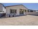 Backyard of a tan house featuring desert landscaping with mountain views and a covered patio at 21276 W Mariposa St, Buckeye, AZ 85396