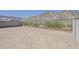 Empty desert backyard surrounded by concrete and wrought iron fence with view of the mountain at 21276 W Mariposa St, Buckeye, AZ 85396
